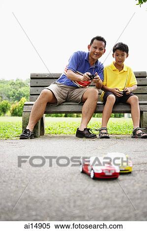 Father and son playing with remote control cars View Large Photo Image Stock Photography - Father and son playing with remote control cars. Fotosearch