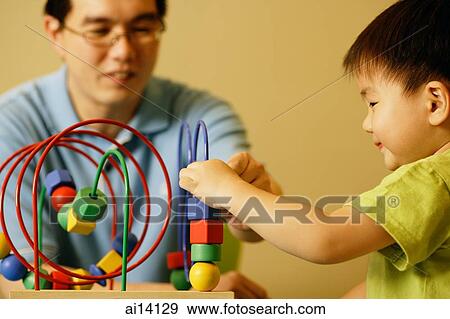 Father and son playing with toy View Large Photo Image Stock Photo - Father and son playing with toy. Fotosearch