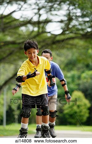 Father and son racing in park View Large Photo Image Stock Photo - Father and son racing in park. Fotosearch