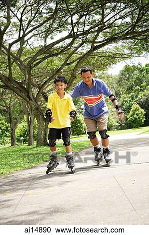 Father and son roller blading in park View Large Photo Image Stock Image - Father and son roller blading in park. Fotosearch