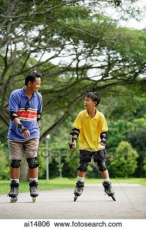 Father and son skating in park View Large Photo Image Stock Photograph - Father and son skating in park. Fotosearch