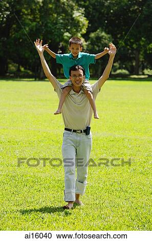 Father carrying son on shoulders View Large Photo Image Stock Image - Father carrying son on shoulders. Fotosearch