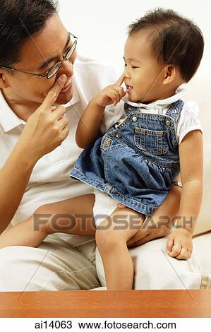 Father holding young daughter, both touching their noses View Large Photo Image Stock Image - Father holding young daughter, both touching their noses. Fotosearch