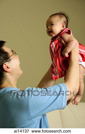 Father lifting baby girl up View Large Photo Image Stock Photo - Father lifting baby girl up. Fotosearch