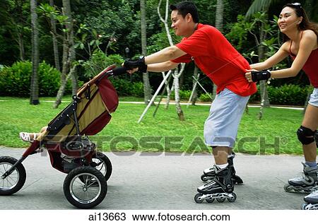Father skating and pushing stroller, mother holding on to waist View Large Photo Image Stock Image - Father skating and pushing stroller, mother holding on to waist. Fotosearch