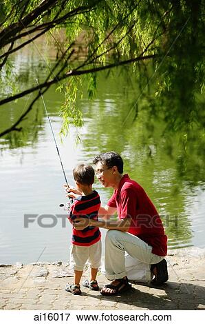 Father teaching son to hold fishing pole View Large Photo Image Stock Photo - Father teaching son to hold fishing pole. Fotosearch