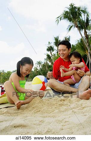 Father with two children playing on beach View Large Photo Image Stock Photography - Father with two children playing on beach. Fotosearch