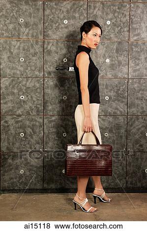Female executive carrying briefcase, knife sticking out of her back View Large Photo Image Stock Photo - Female executive carrying briefcase, knife sticking out of her back. Fotosearch