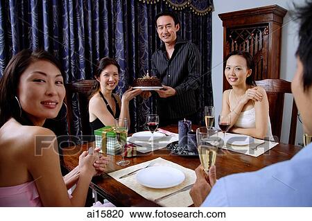 Friends at home, man and woman holding cake, looking at camera View Large Photo Image Stock Image - Friends at home, man and woman holding cake, looking at camera. Fotosearch