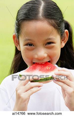 Girl eating slice of watermelon View Large Photo Image Stock Photograph - Girl eating slice of watermelon. Fotosearch