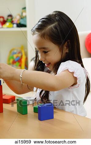 Girl playing with building blocks View Large Photo Image Stock Photo - Girl playing with building blocks. Fotosearch