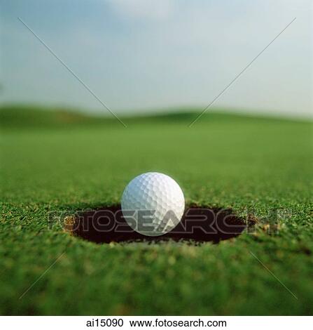 Golf ball dropping in to hole View Large Photo Image Stock Image - Golf ball dropping in to hole. Fotosearch