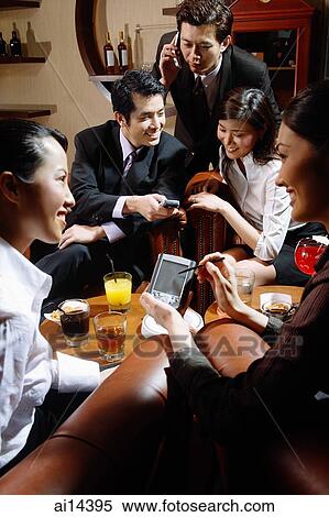 Group of young executives having a discussion over drinks at entertainment club View Large Photo Image Stock Photography - Group of young executives having a discussion over drinks at entertainment club. Fotosearch