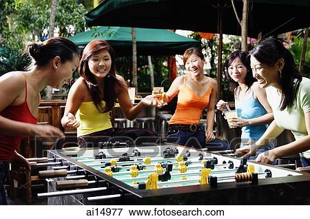 Group of young women playing foosball View Large Photo Image Stock Photo - Group of young women playing foosball. Fotosearch