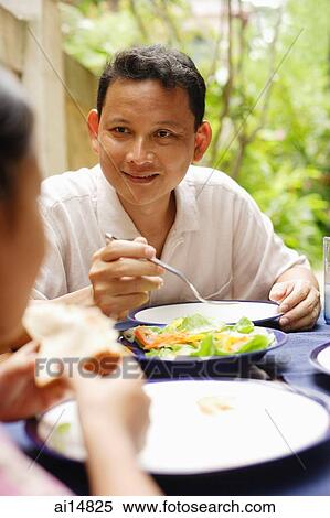 Stock Photography - Man eating, portrait. Fotosearch