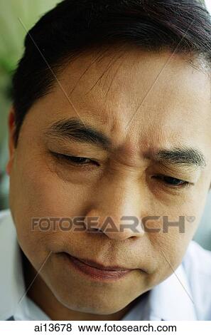 Man frowning, headshot View Large Photo Image Stock Photo - Man frowning, headshot. Fotosearch
