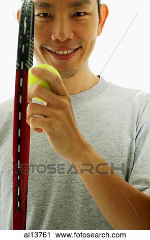 Man holding tennis racket and tennis ball View Large Photo Image Stock Image - Man holding tennis racket and tennis ball. Fotosearch