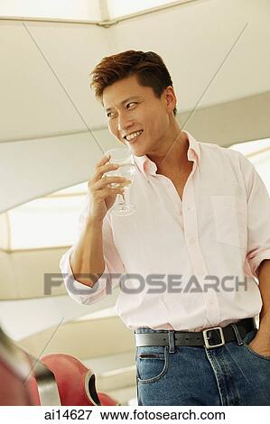 Man holding wine glass, looking away View Large Photo Image Stock Photo - Man holding wine glass, looking away. Fotosearch
