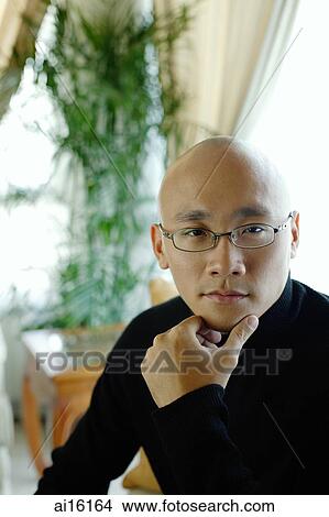 Man in black turtleneck, looking at camera, hand on chin View Large Photo Image Picture - Man in black turtleneck, looking at camera, hand on chin. Fotosearch