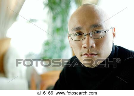 Stock Photograph - Man in black turtleneck, looking at camera, portrait. Fotosearch