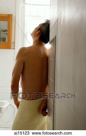 Man leaning on wall in toilet, wearing towel, looking away View Large Photo Image Stock Image - Man leaning on wall in toilet, wearing towel, looking away. Fotosearch