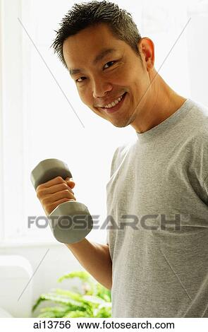 Man lifting weights, looking at camera View Large Photo Image Stock Photograph - Man lifting weights, looking at camera. Fotosearch