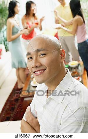 Man looking at camera, people in the background View Large Photo Image Stock Photo - Man looking at camera, people in the background. Fotosearch