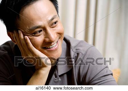 Stock Image - Man looking away, hand on face. Fotosearch