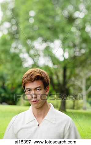 Stock Photo - Man outdoors, looking at camera, head shot. Fotosearch