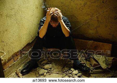 Man sitting in corner of empty room, hand on head View Large Photo Image Stock Image - Man sitting in corner of empty room, hand on head. Fotosearch