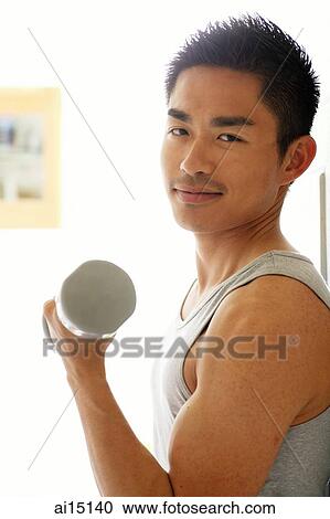 Man using dumbbells, looking at camera View Large Photo Image Stock Image - Man using dumbbells, looking at camera. Fotosearch