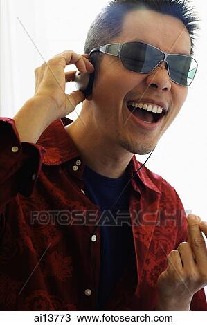 Man wearing headphones and sunglasses, mouth open View Large Photo Image Stock Image - Man wearing headphones and sunglasses, mouth open. Fotosearch