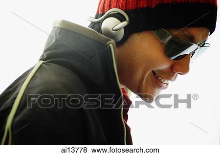 Man wearing headphones, looking away View Large Photo Image Stock Photo - Man wearing headphones, looking away. Fotosearch
