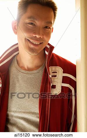 Man wearing track suit jacket, smiling at camera View Large Photo Image Stock Image - Man wearing track suit jacket, smiling at camera. Fotosearch