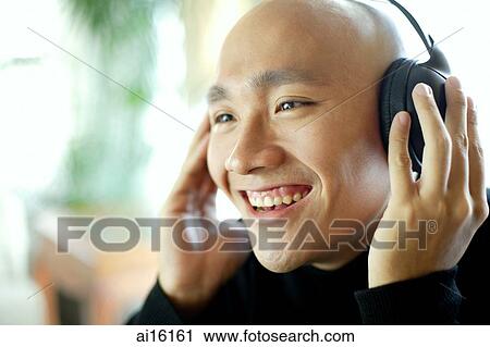 Stock Image - Man with headphones, listening to music. Fotosearch