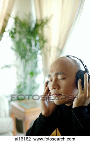 Man with headphones, listening to music, eyes closed View Large Photo Image Stock Image - Man with headphones, listening to music, eyes closed. Fotosearch