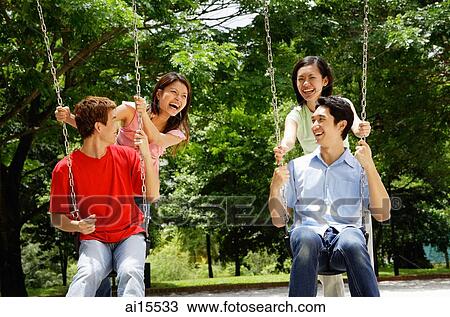 Men on swings, women pushing them View Large Photo Image Stock Image - Men on swings, women pushing them. Fotosearch