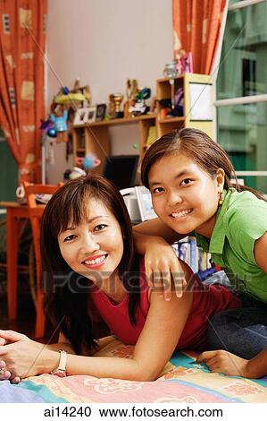 Mother and daughter, looking at camera, portrait View Large Photo Image Stock Image - Mother and daughter, looking at camera, portrait. Fotosearch