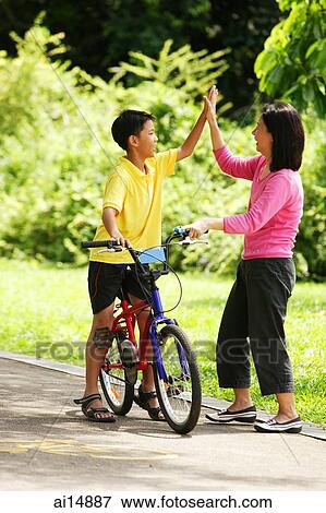 Mother and son giving high fives View Large Photo Image Stock Photo - Mother and son giving high fives. Fotosearch