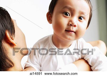 Mother carrying baby boy over her shoulder View Large Photo Image Stock Image - Mother carrying baby boy over her shoulder. Fotosearch