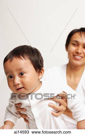 Mother carrying baby boy View Large Photo Image Stock Image - Mother carrying baby boy. Fotosearch