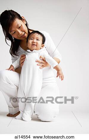 Mother holding baby boy, portrait View Large Photo Image Picture - Mother holding baby boy, portrait. Fotosearch