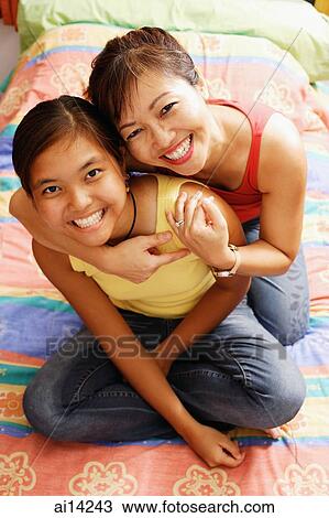 Mother hugging daughter, portrait View Large Photo Image Stock Image - Mother hugging daughter, portrait. Fotosearch