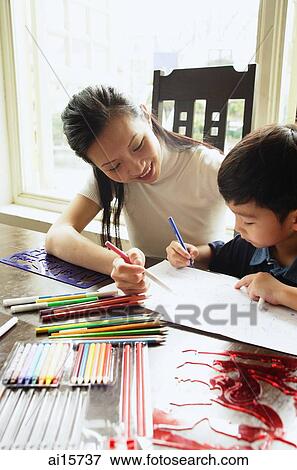Mother sitting with son, drawing with colour pencils View Large Photo Image Stock Photo - Mother sitting with son, drawing with colour pencils. Fotosearch