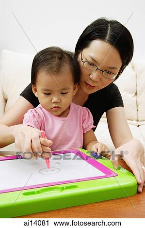 Mother teaching daughter to draw View Large Photo Image Stock Image - Mother teaching daughter to draw. Fotosearch