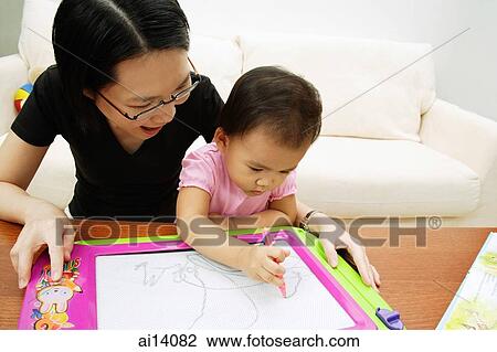 Mother watching daughter draw View Large Photo Image Stock Image - Mother watching daughter draw. Fotosearch