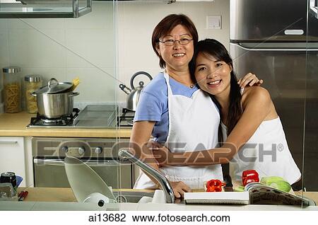 Mother with adult daughter in kitchen, looking at camera View Large Photo Image Stock Image - Mother with adult daughter in kitchen, looking at camera. Fotosearch