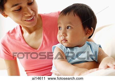 Mother with arm around baby boy View Large Photo Image Stock Image - Mother with arm around baby boy. Fotosearch