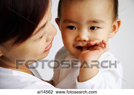 Mother with baby, baby sucking thumb View Large Photo Image Stock Image - Mother with baby, baby sucking thumb. Fotosearch