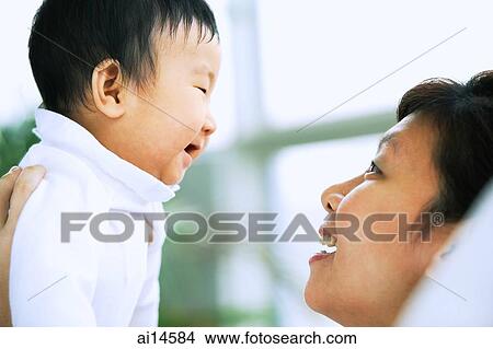 Picture - Mother with baby boy, face to face. Fotosearch